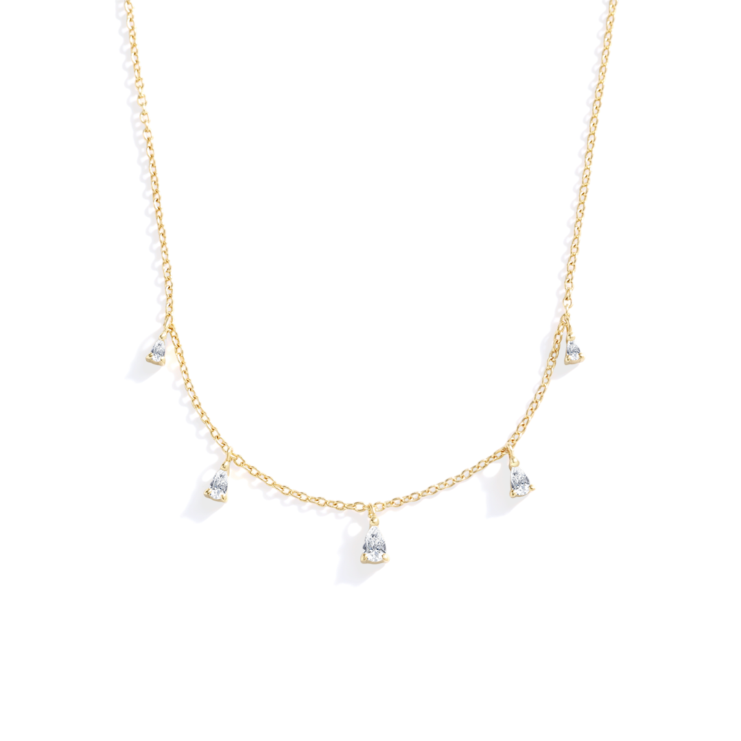 Gold necklace with small diamond-like pendants on a white background