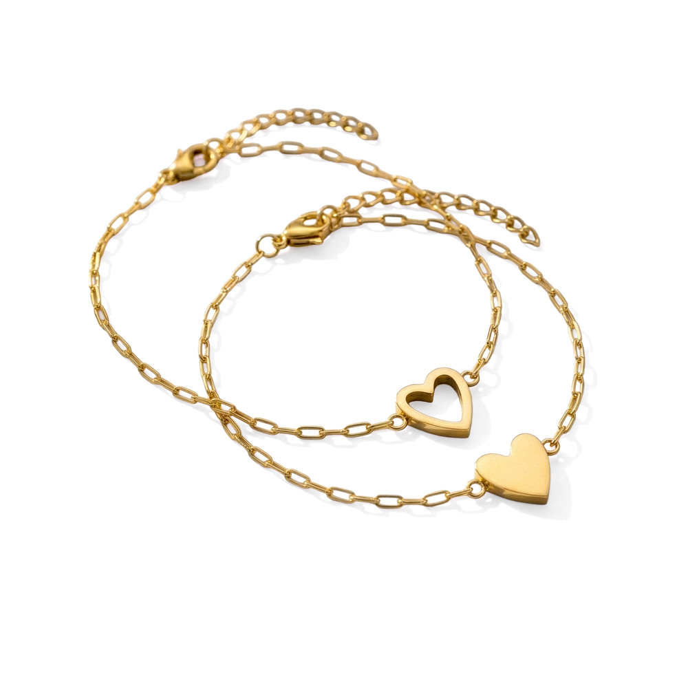 Two gold heart-shaped necklaces on a white background