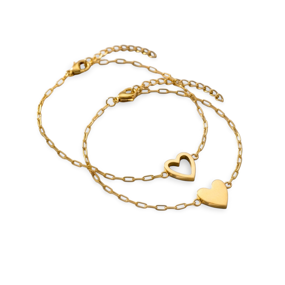 Two gold heart-shaped necklaces on a white background