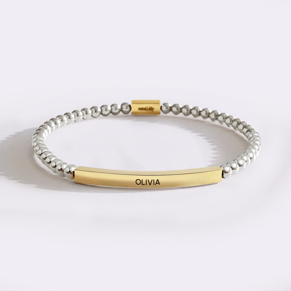 Bracelet with gold and silver beads on a white background