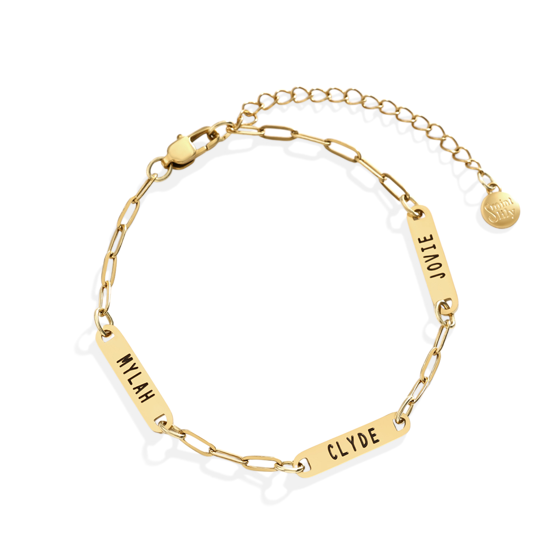 Gold chain bracelet with engraved names on a white background