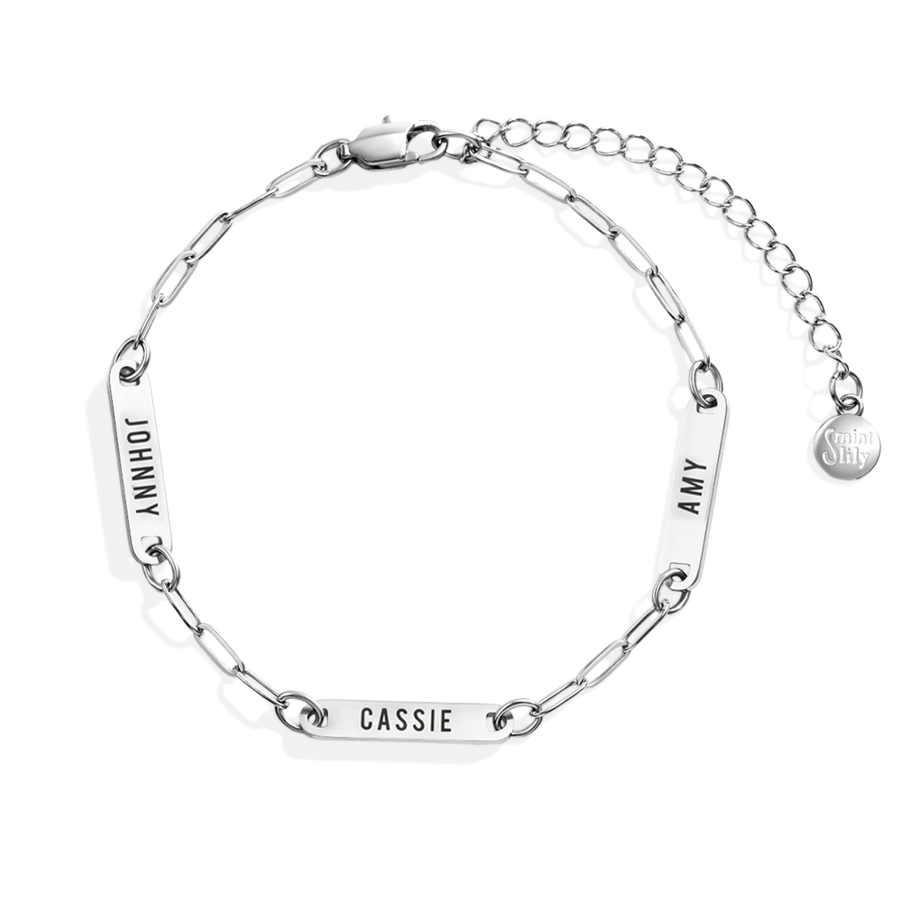 Silver chain bracelet with engraved names on a white background