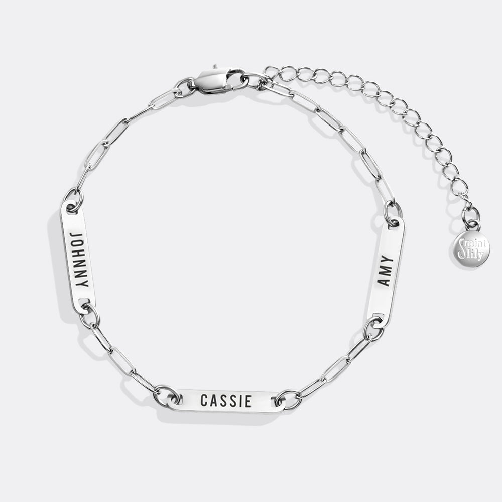 Silver chain bracelet with engraved names on a white background