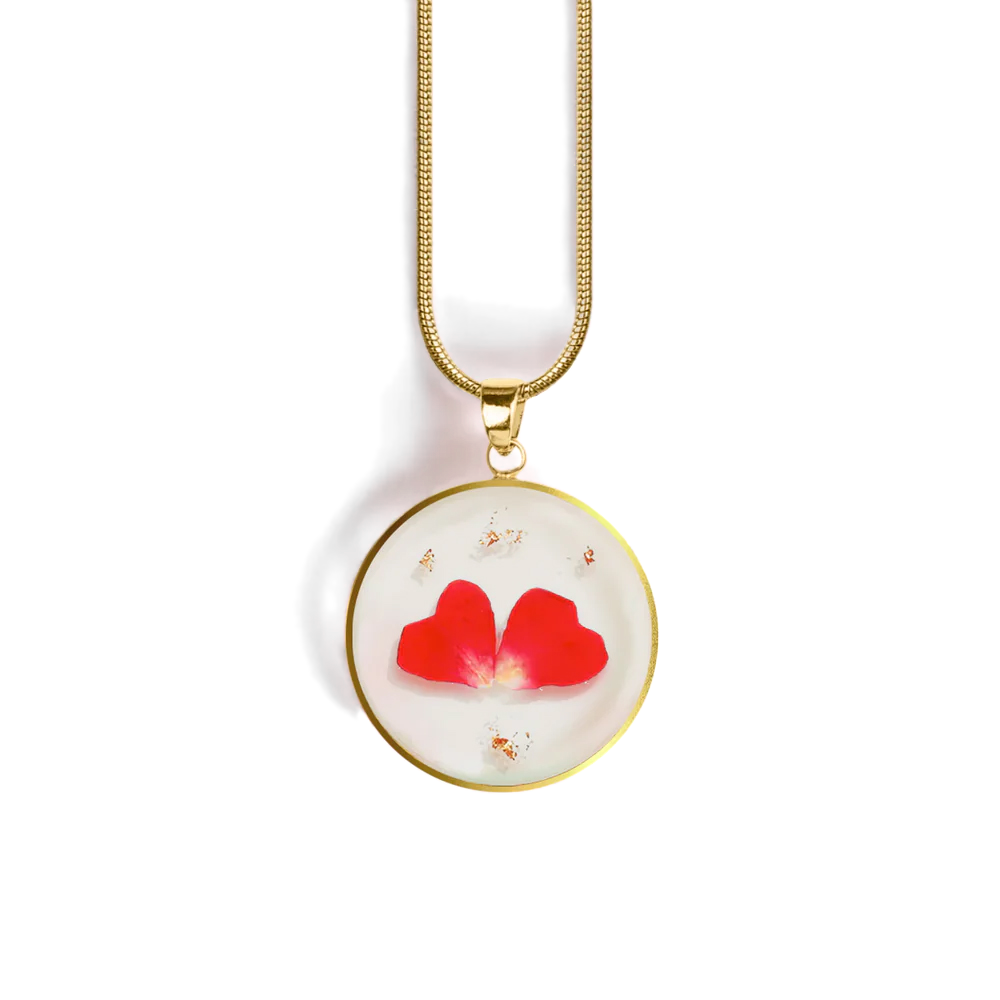 Necklace with a round pendant featuring red flowers on a white background