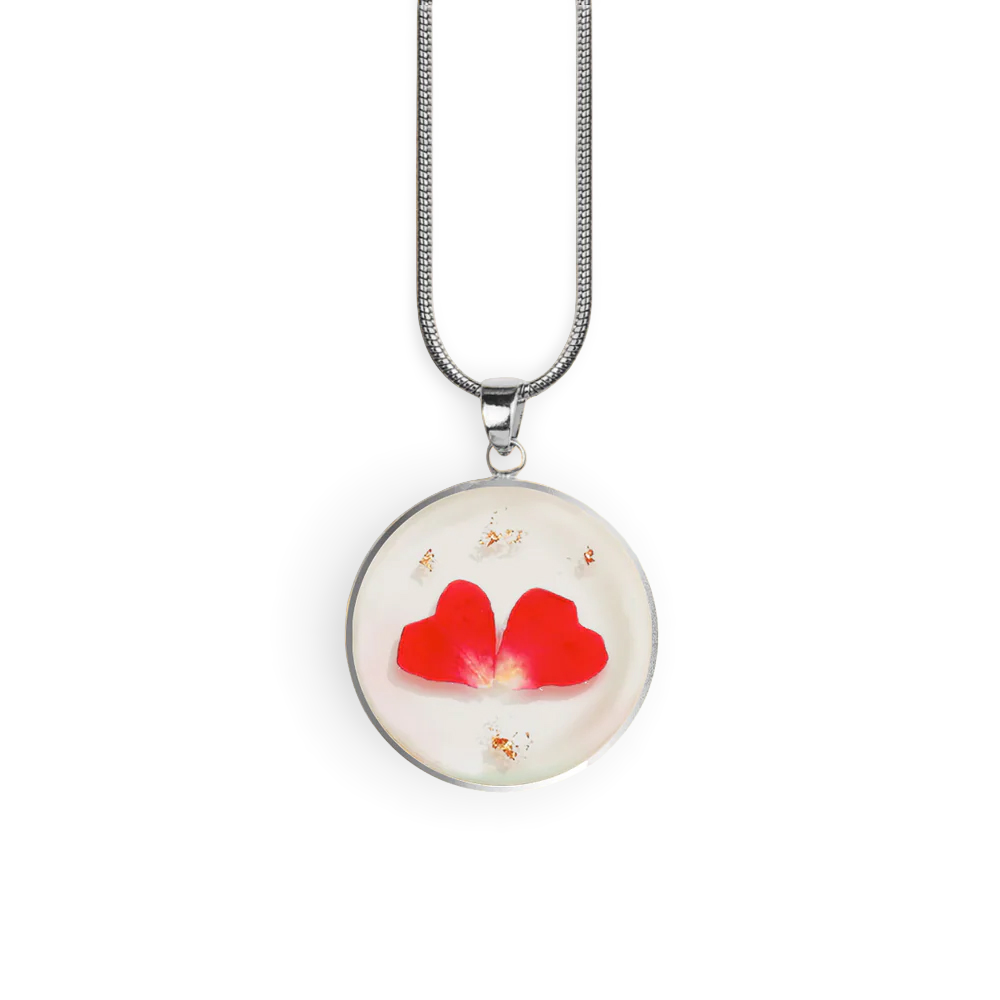 Necklace with a round pendant featuring red hearts on a white background