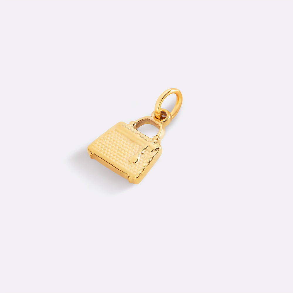 Gold purse-shaped pendant on a light gray background