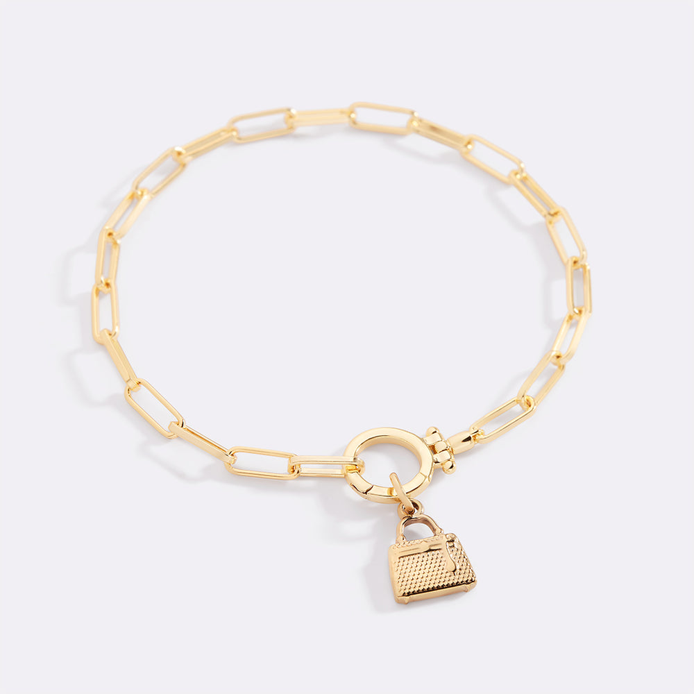 Gold bracelet with a heart-shaped padlock charm on a light gray background