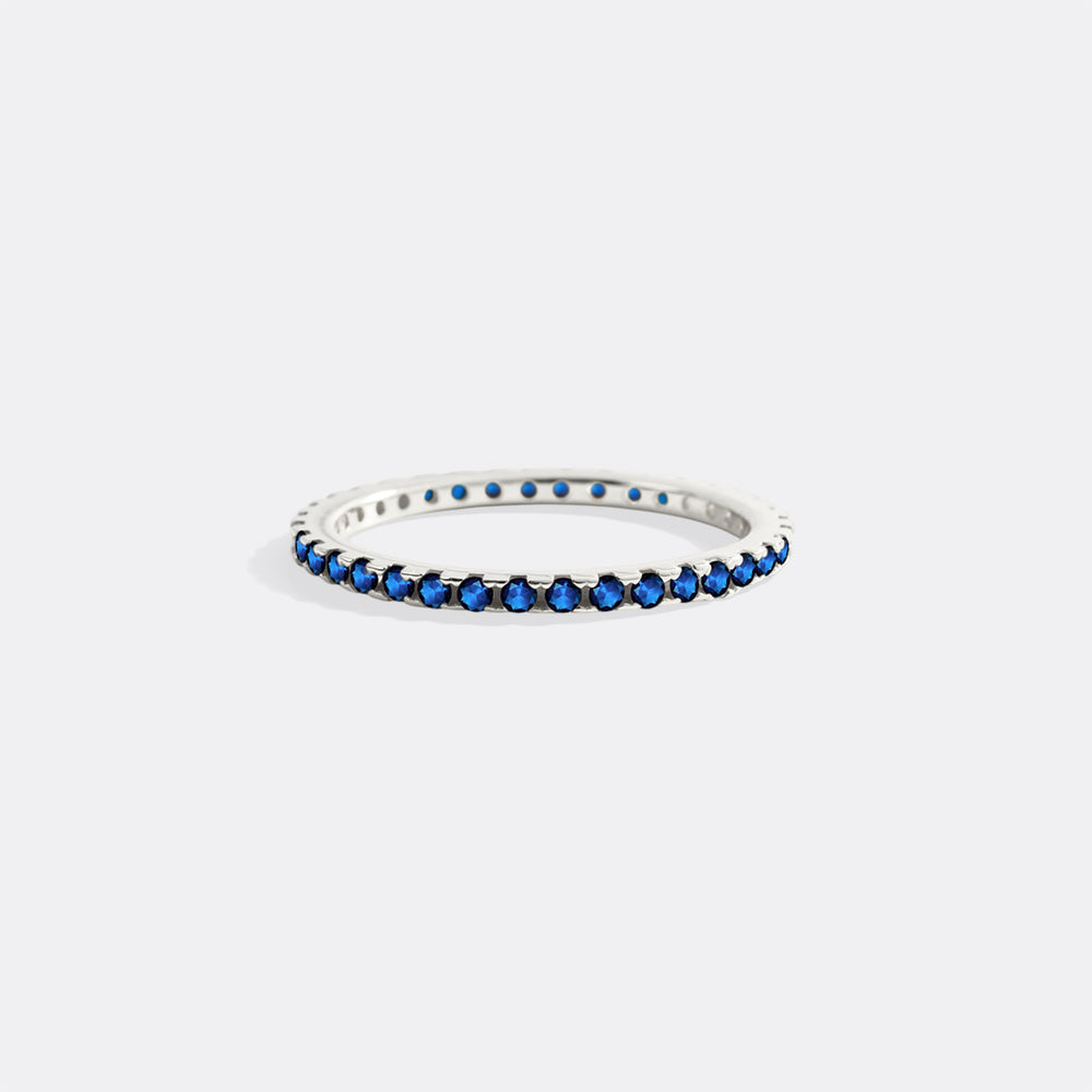 Silver ring with blue stones on a white background