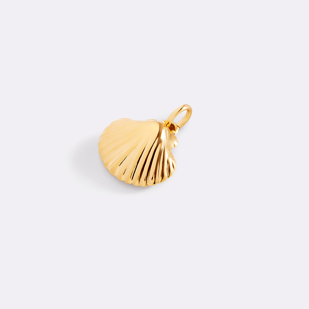 Gold shell pendant on a light gray background