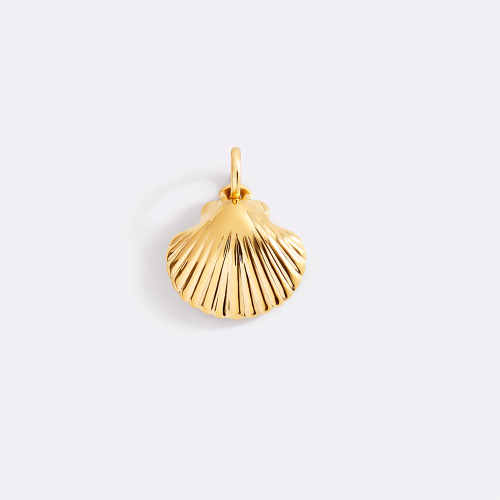 Gold shell pendant on a light gray background
