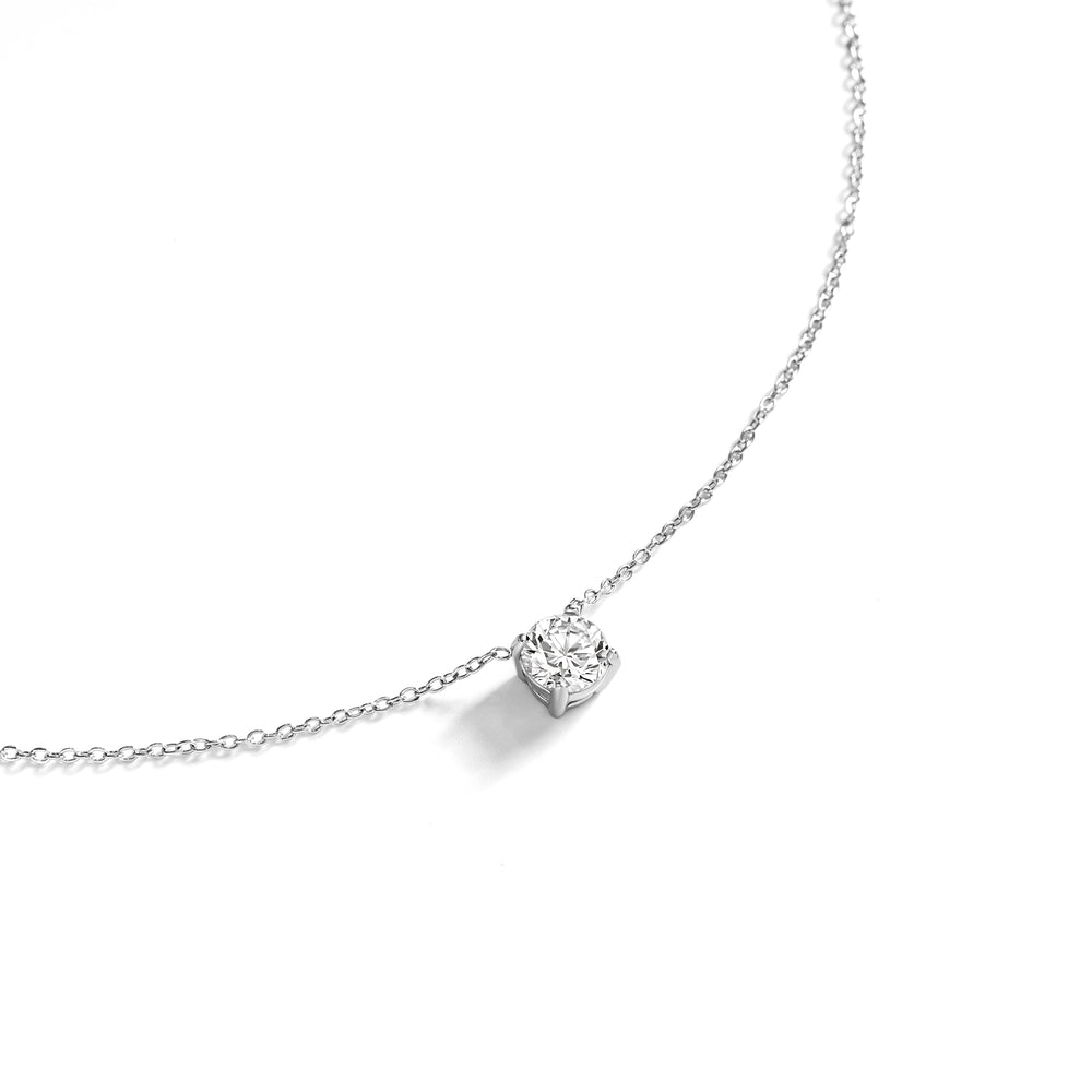 Silver necklace with a heart-shaped diamond pendant on a white background