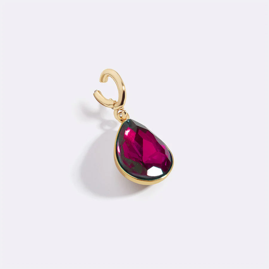 Gold pendant with a pink teardrop-shaped gemstone on a white background