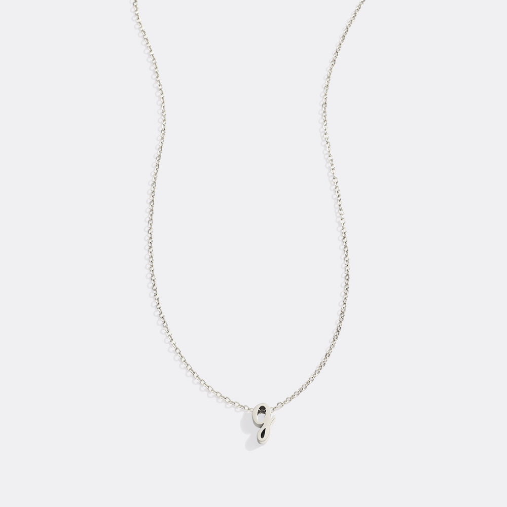 Silver necklace with a small pendant on a white background