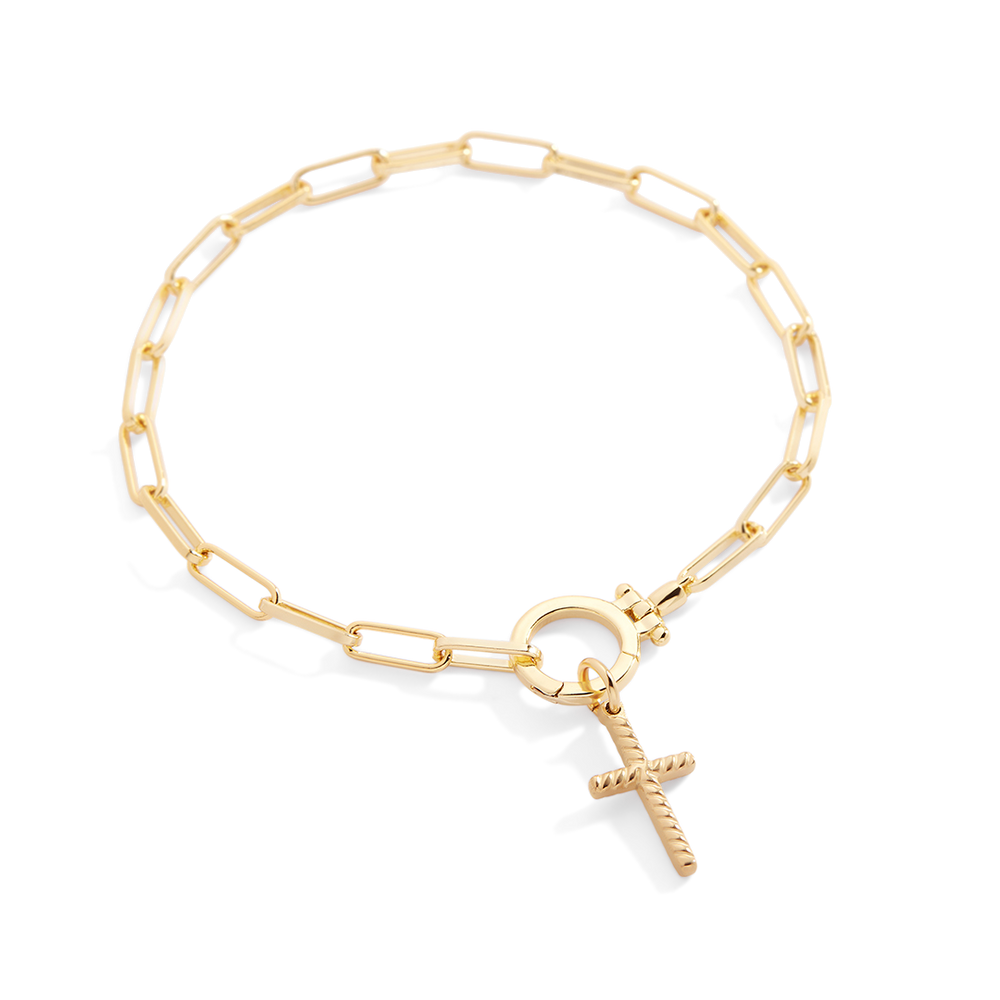 Gold bracelet with a unique charm on a light gray background
