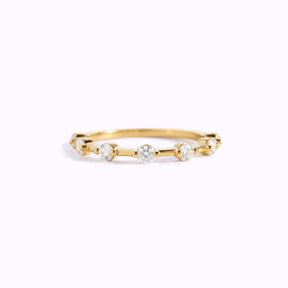 Gold ring with small diamonds on a white background