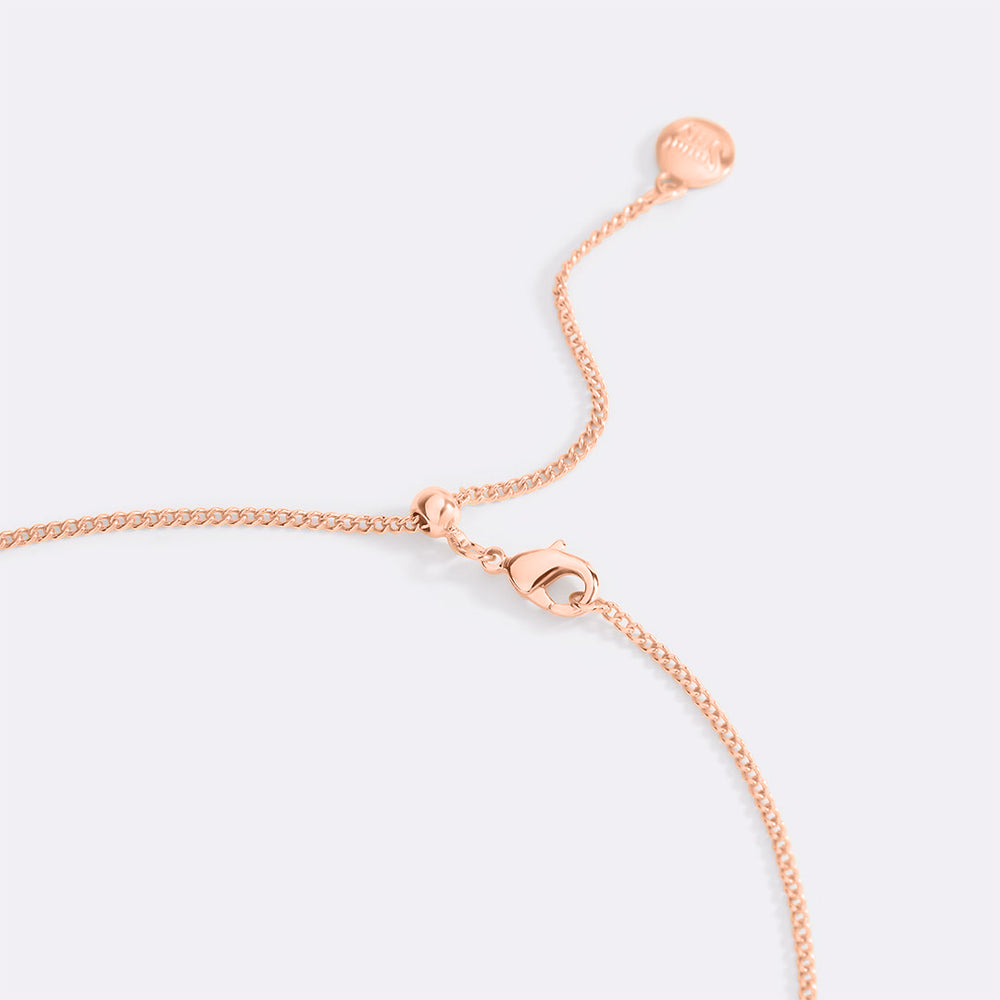 Rose gold bracelet on a light gray background