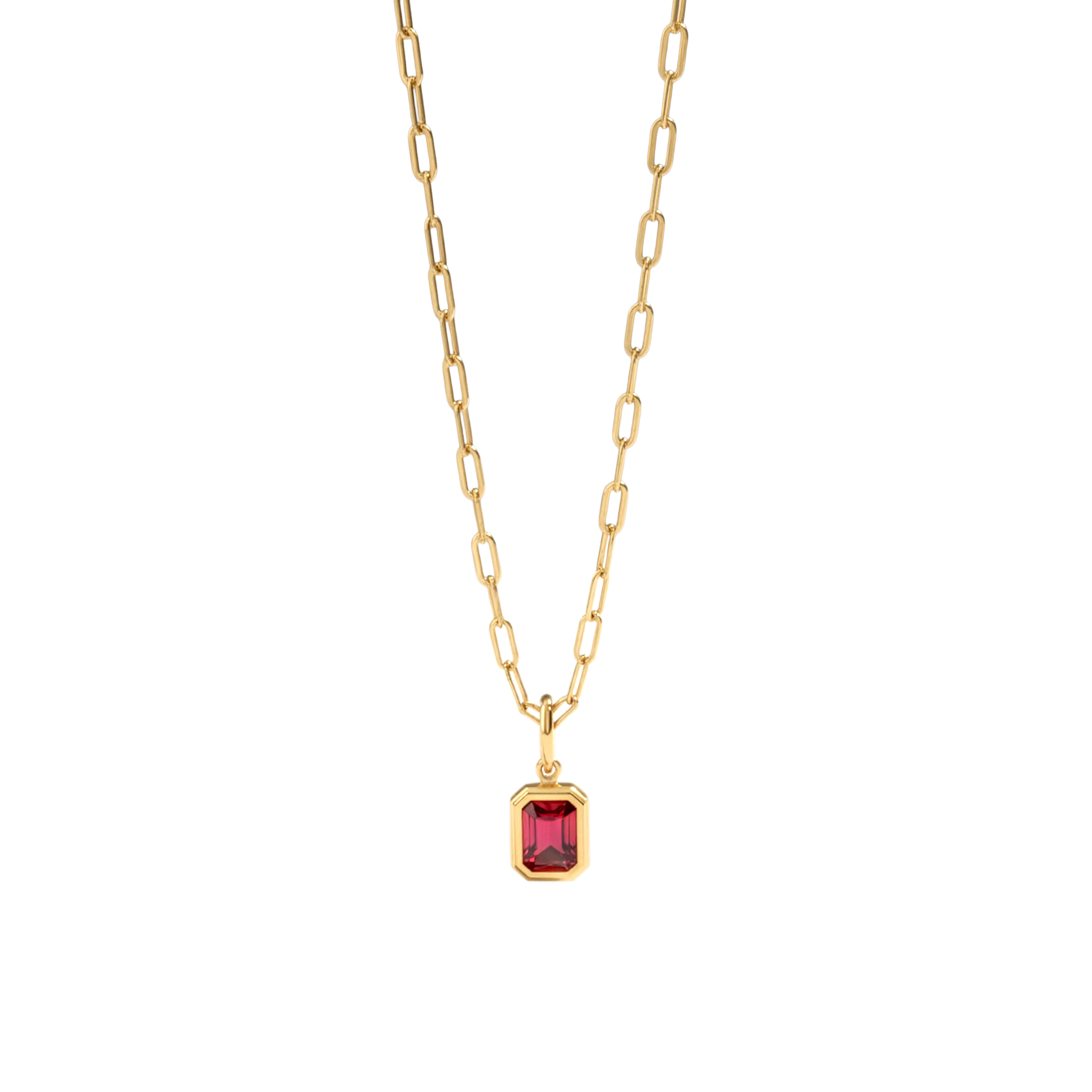 Gold necklace with a red gemstone pendant on a light gray background