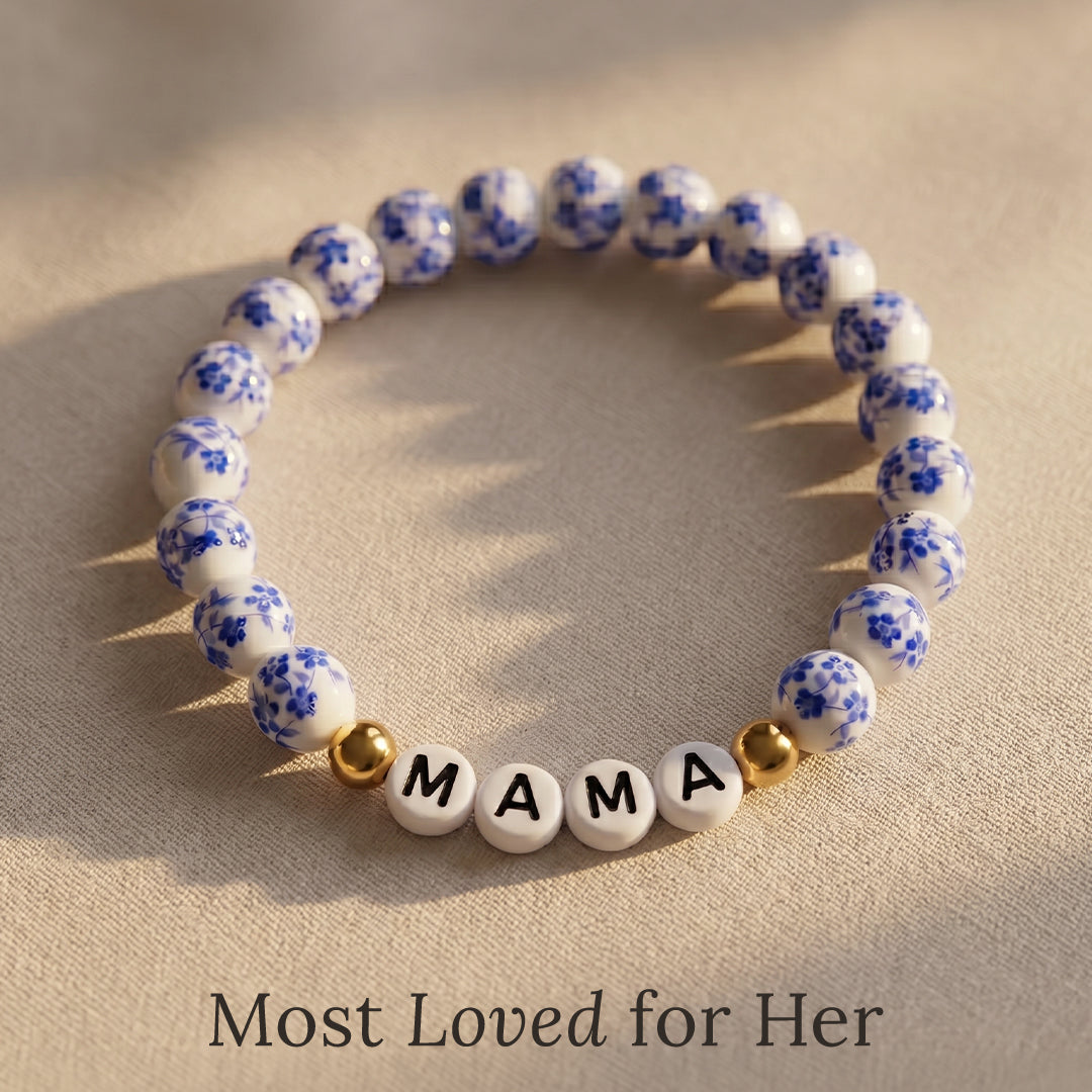 Bracelet with blue floral beads and 'MAMA' on a beige background