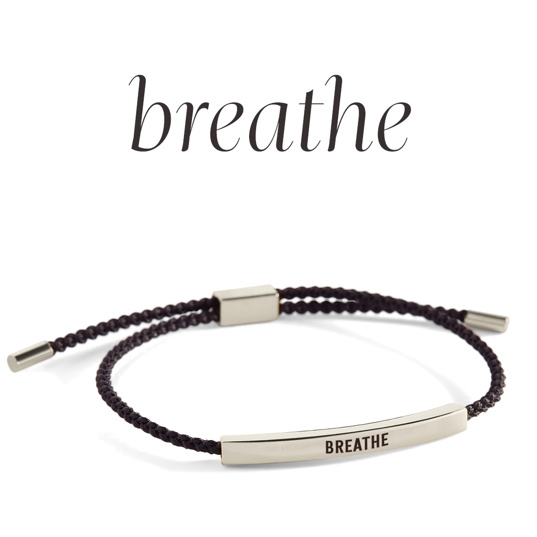Bracelet with 'BREATHE' engraving on a light background