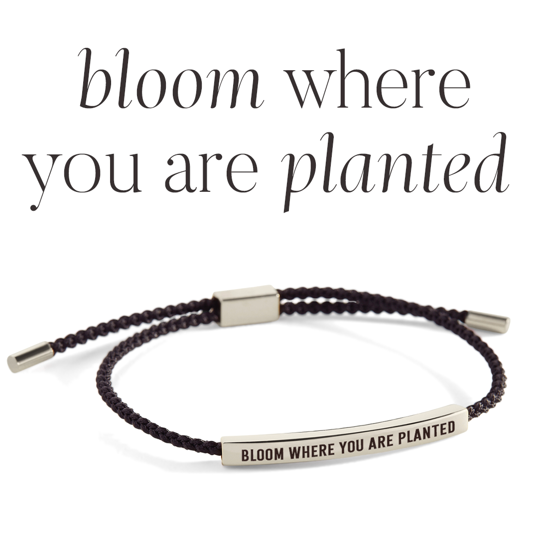 Bracelet with 'Bloom Where You Are Planted' message on a light background