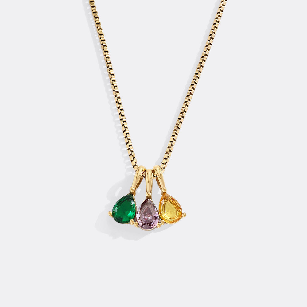 Necklace with three colored gemstones on a white background