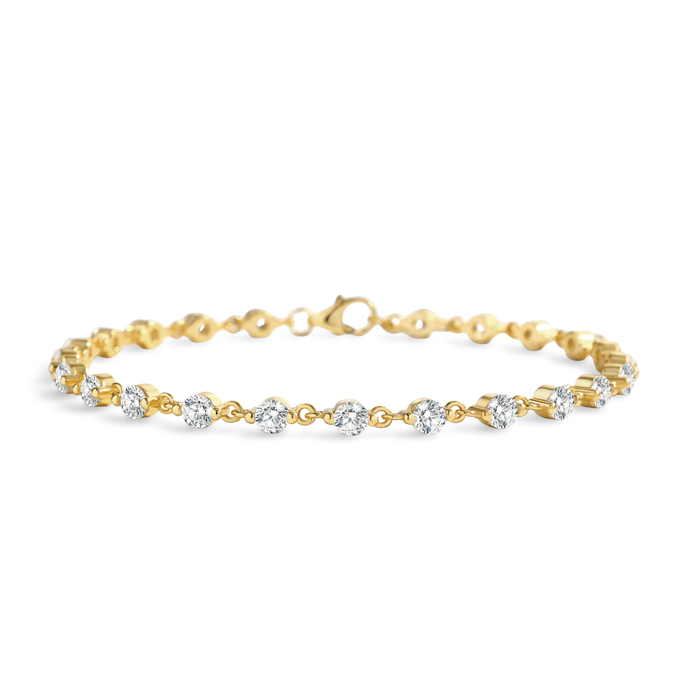 Gold bracelet with clear stones on a light gray background