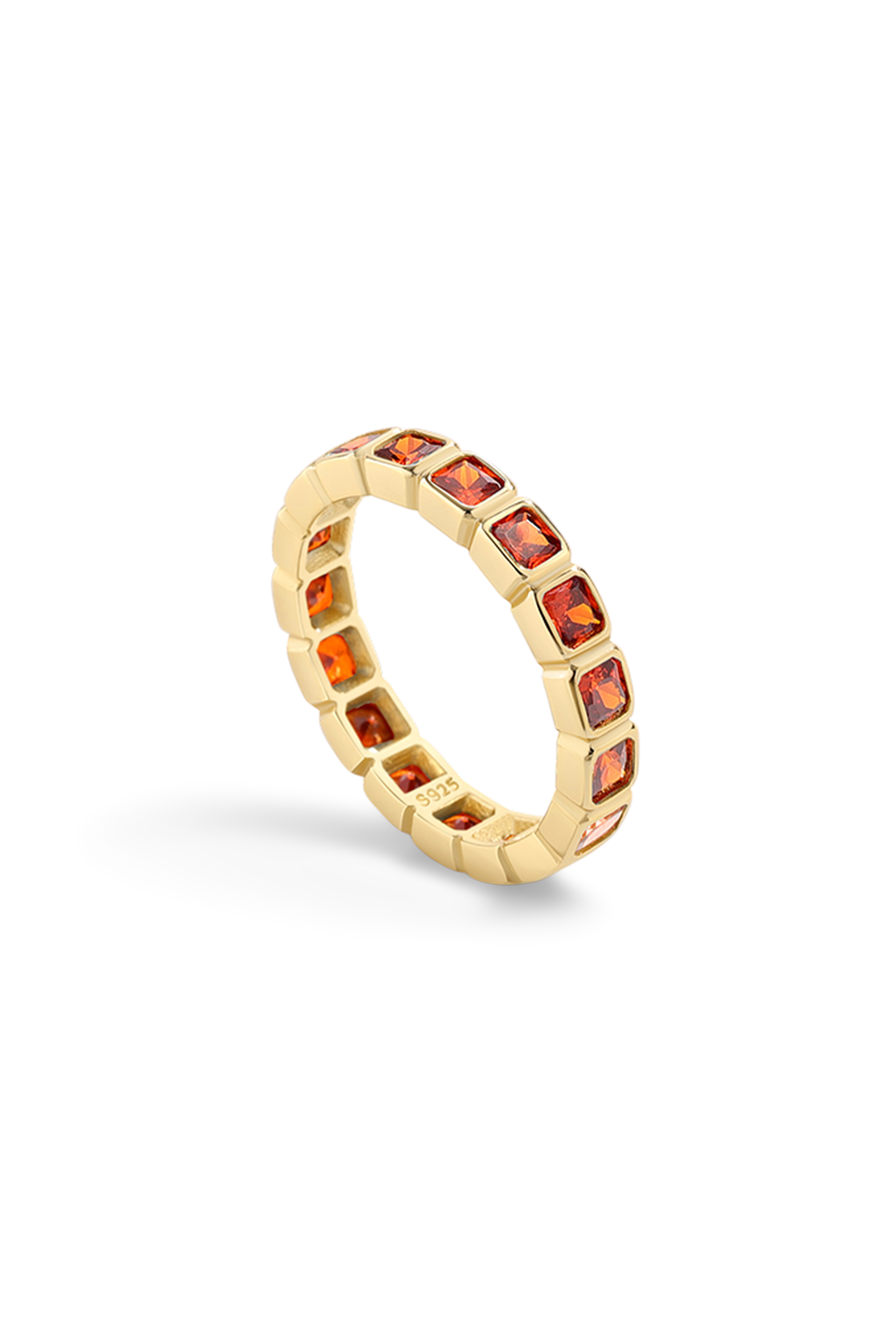 Gold ring with embedded red gemstones on a white background