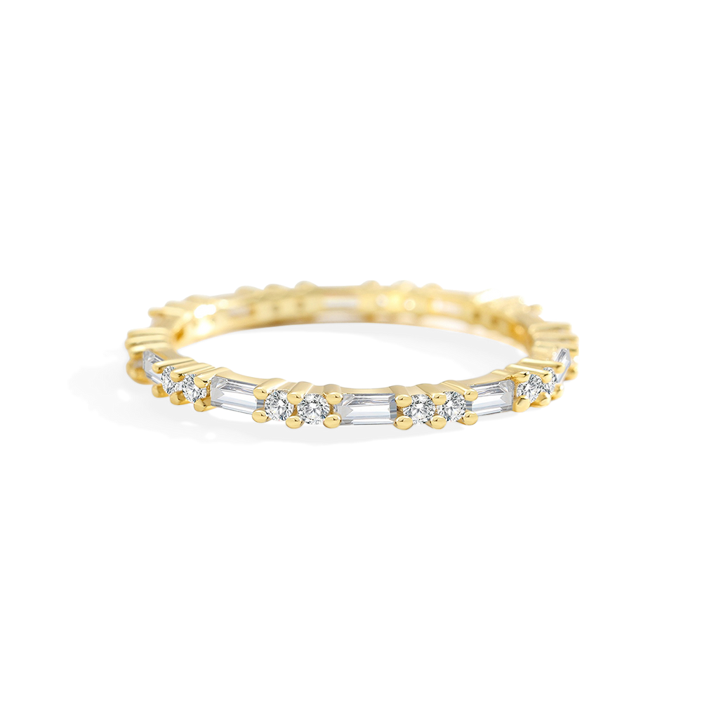 Gold ring with embedded diamonds on a light gray background