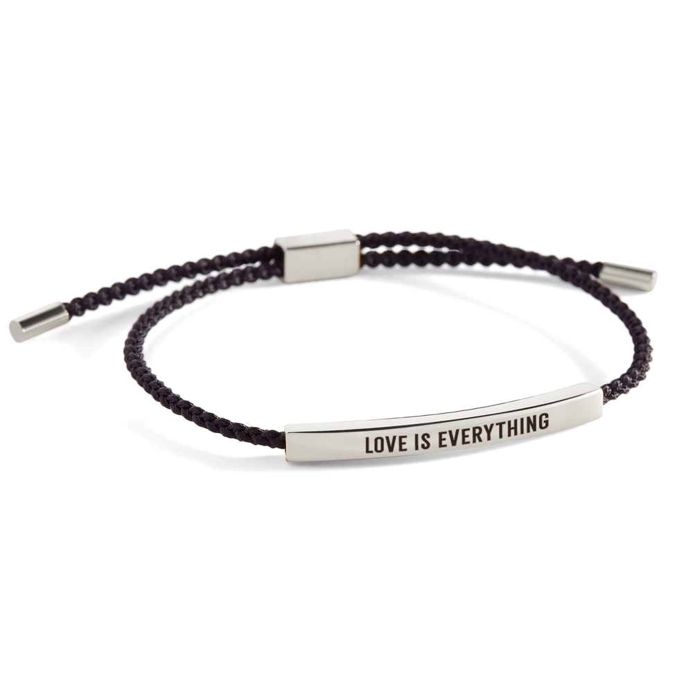 An inspirational tube bracelet with the message 'love is everything' printed on it, displayed on a white background with the text 'love is everything' also shown above the bracelet.