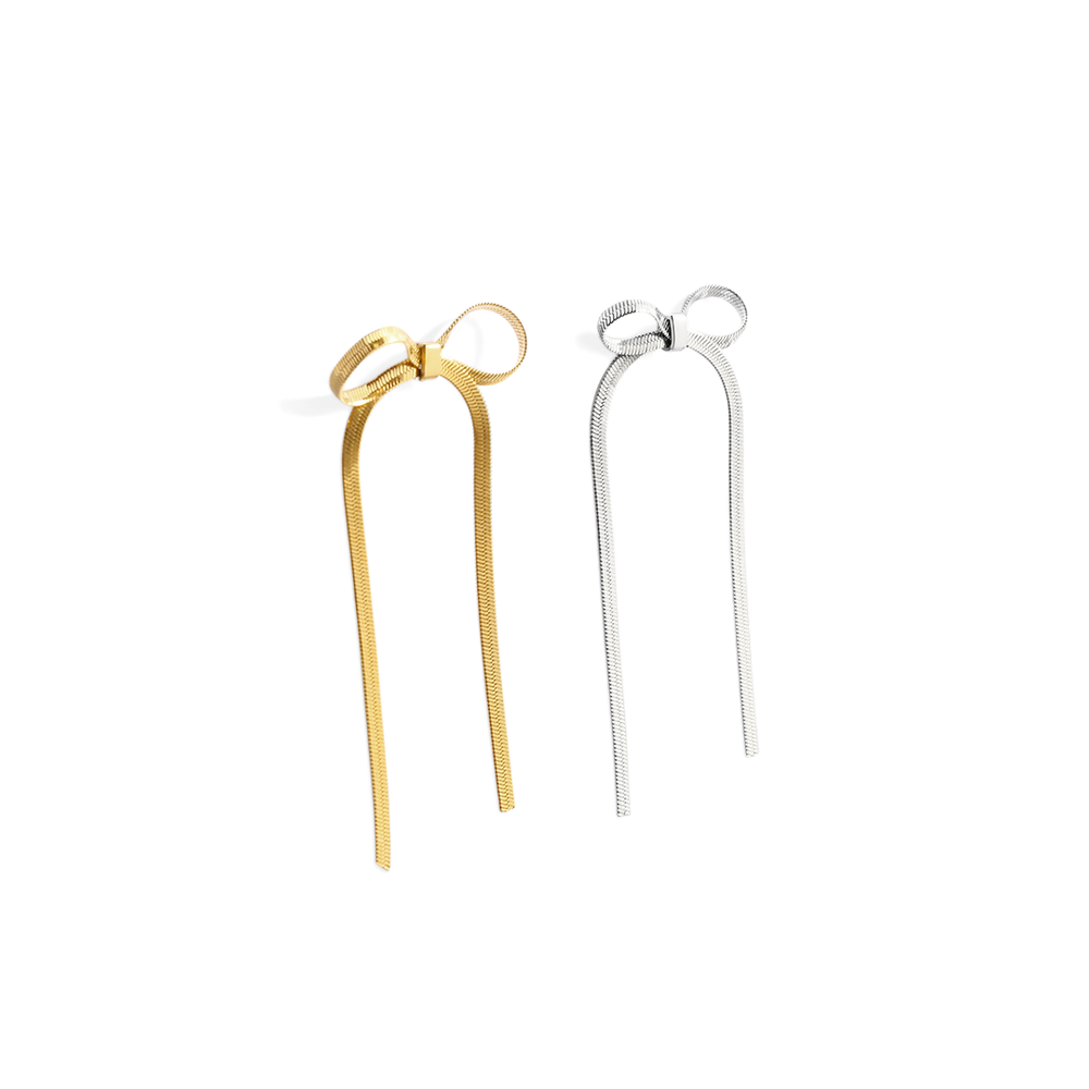 Gold and silver hairpin with bow design on a white background