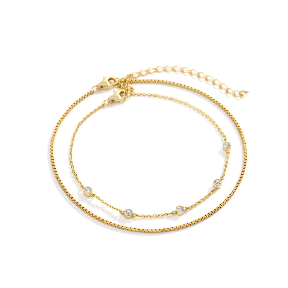 Gold bracelet with small beads on a white background