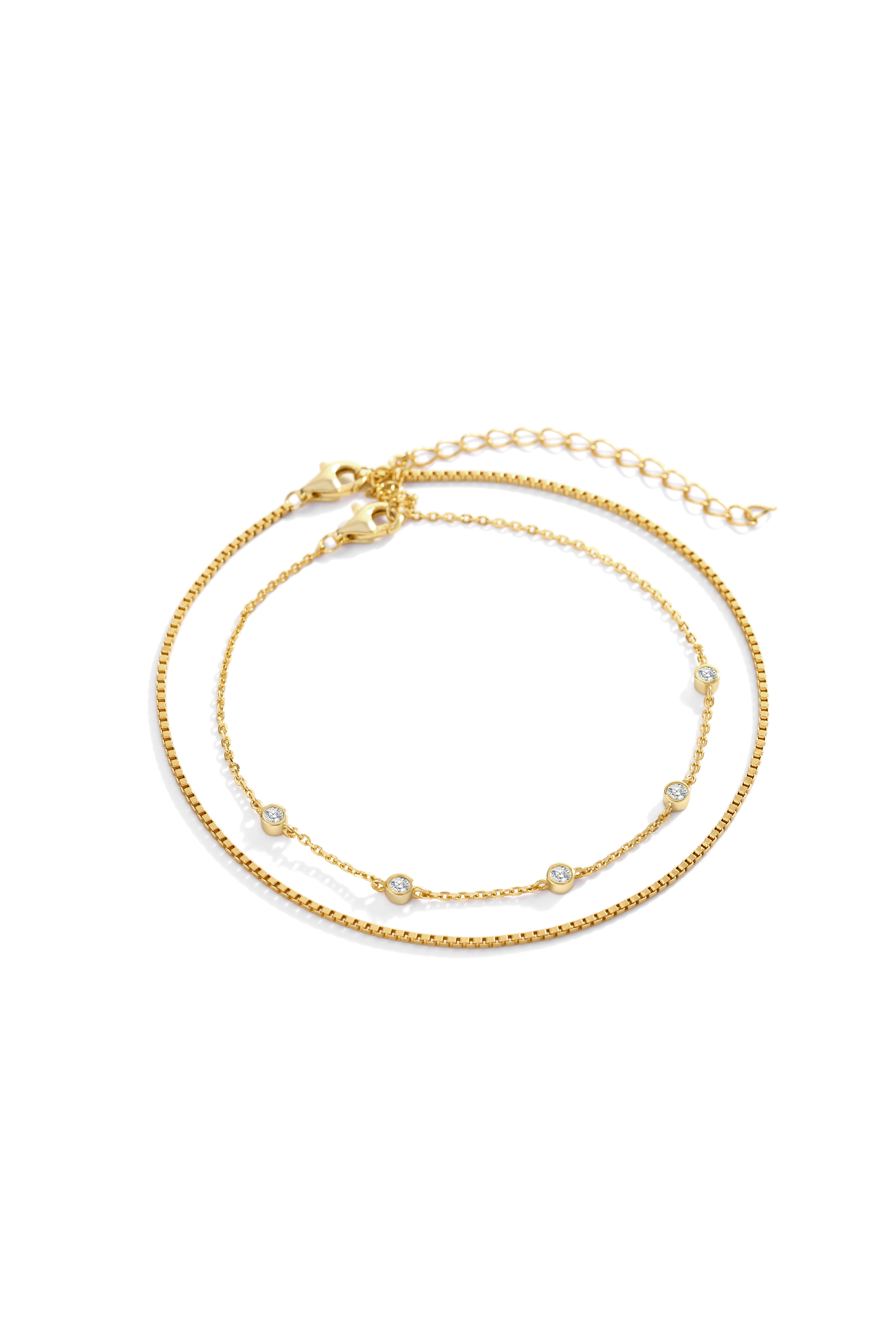 Gold bracelet with small beads on a white background