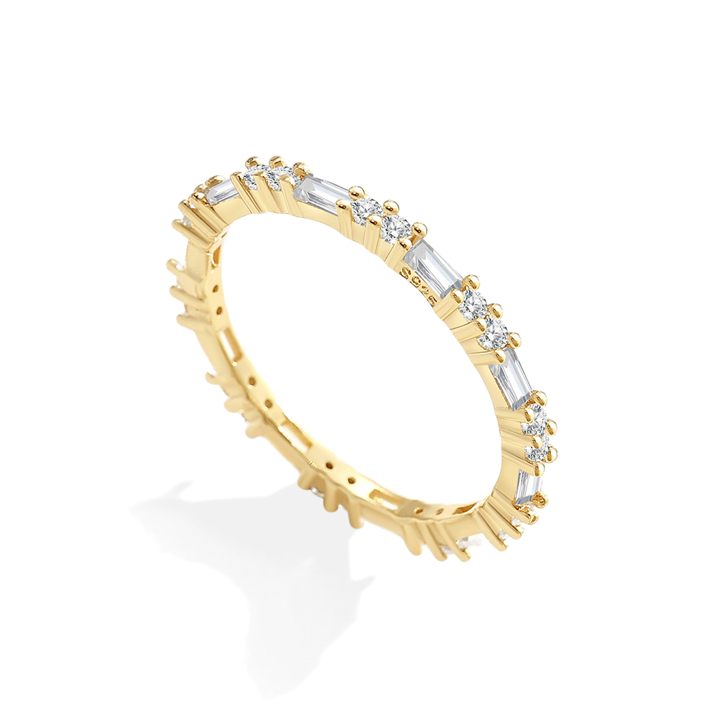 Gold ring with diamond accents on a white background