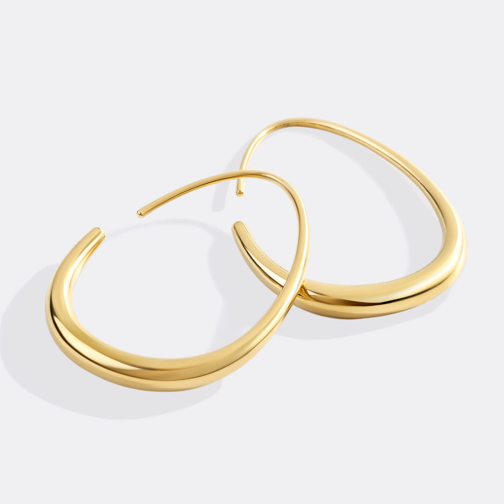 Gold hoop earrings on a white background