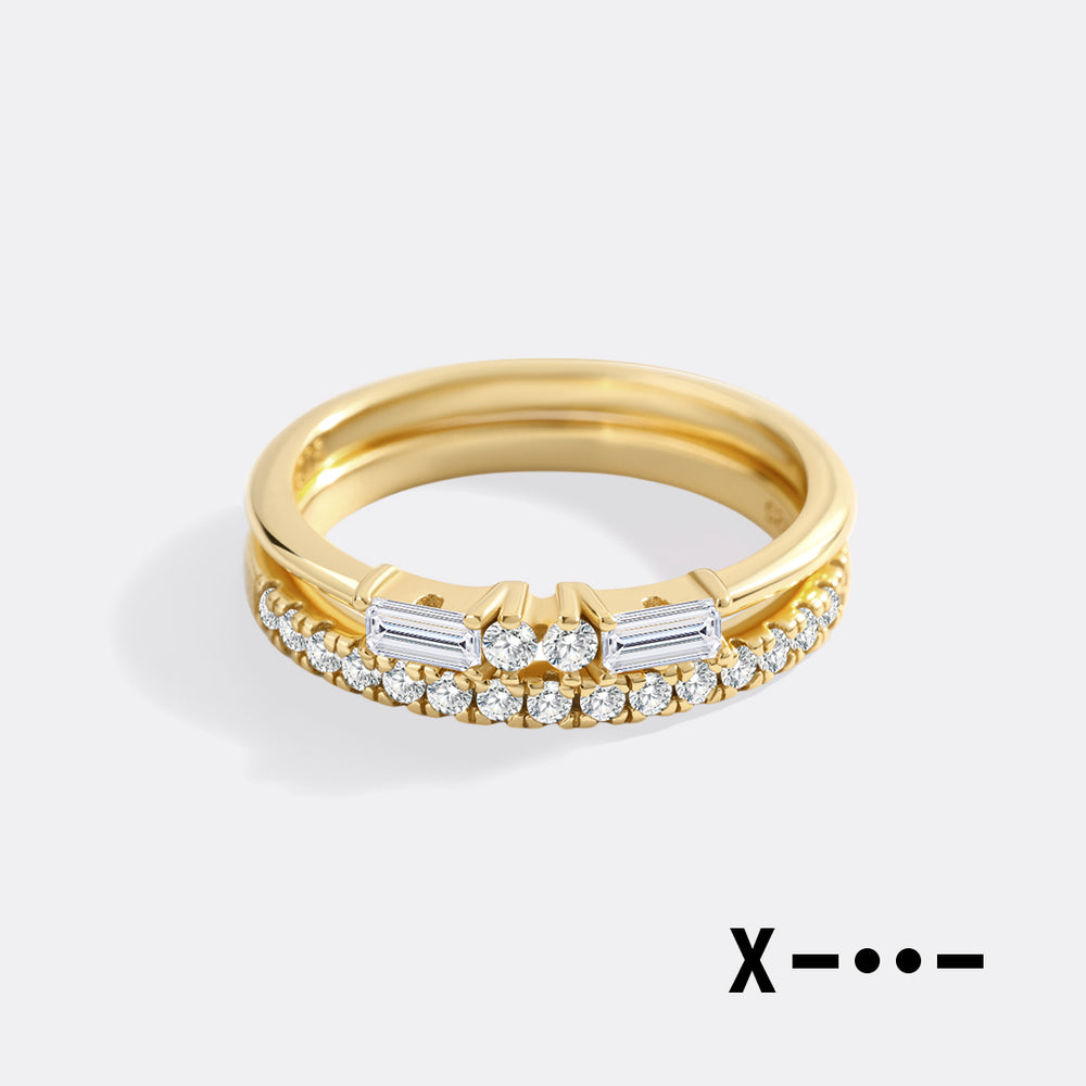 Gold ring with diamonds on a light gray background