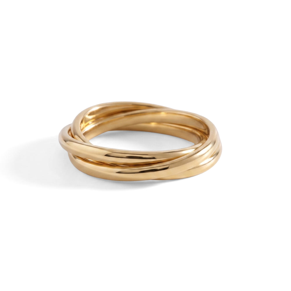 A gold interlocking fidget ring laid flat on a white background.