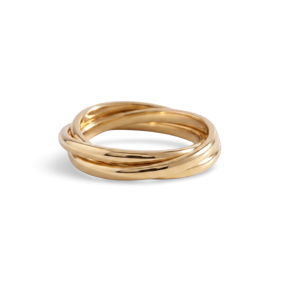 A gold interlocking fidget ring laid flat on a white background.