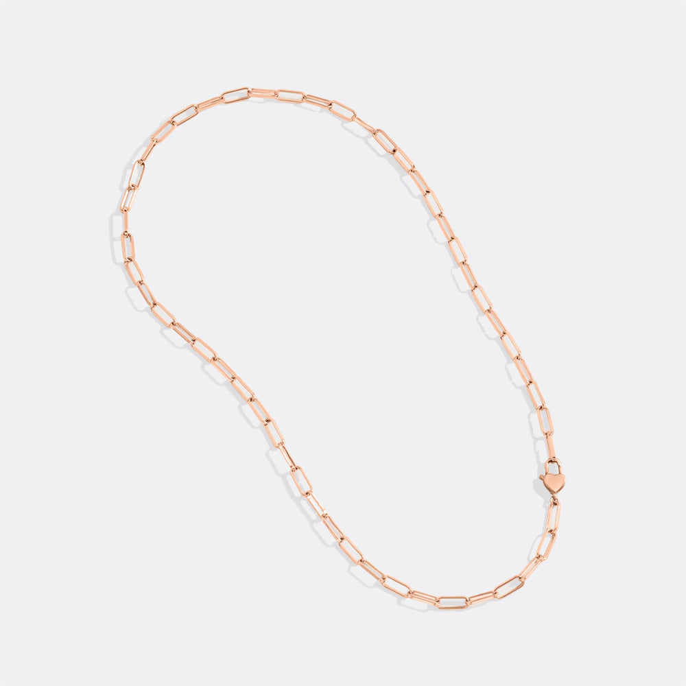 Rose gold chain necklace on a light gray background
