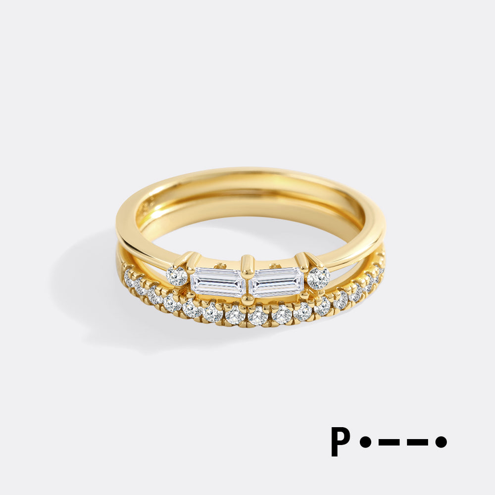 Gold ring with diamond accents on a light gray background
