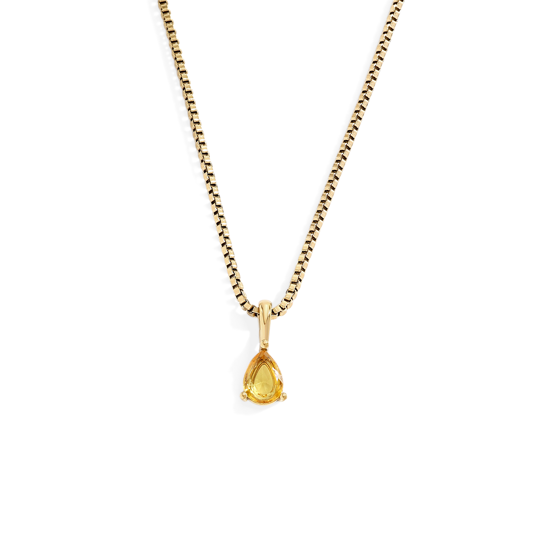 Gold necklace with a teardrop-shaped pendant on a white background