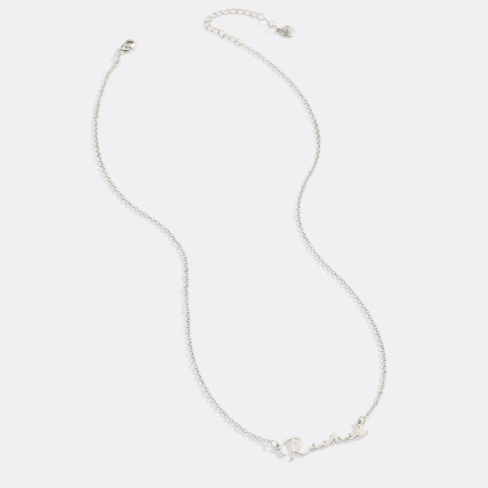 Silver necklace on a light gray background