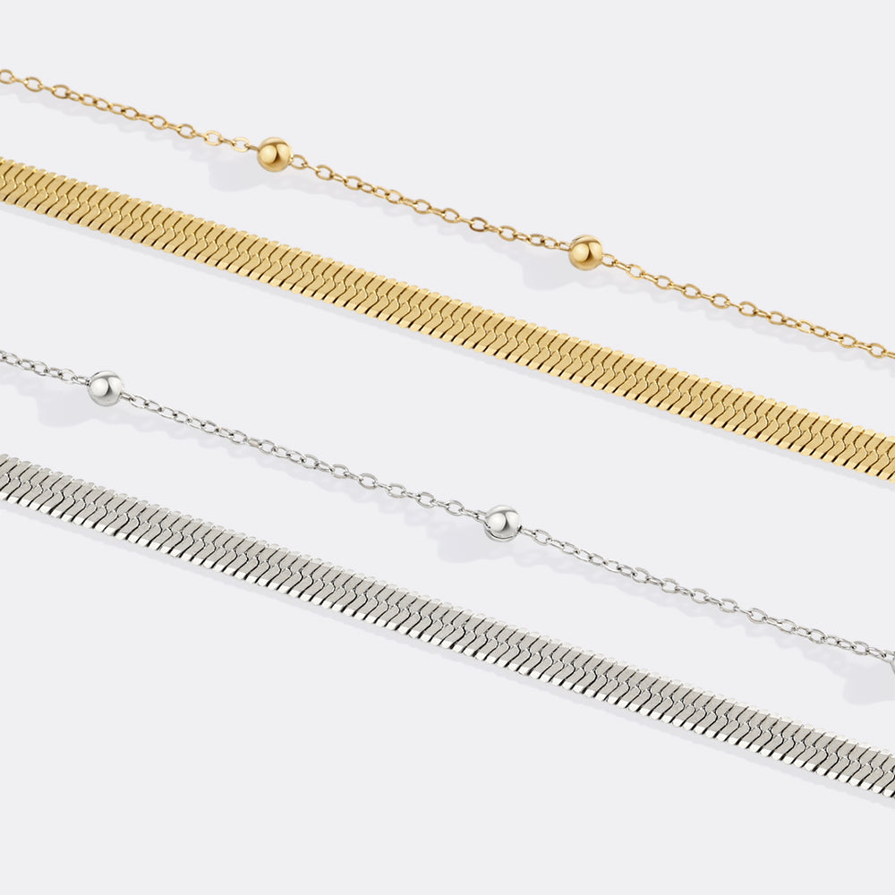 Two gold and silver chain necklaces on a white background