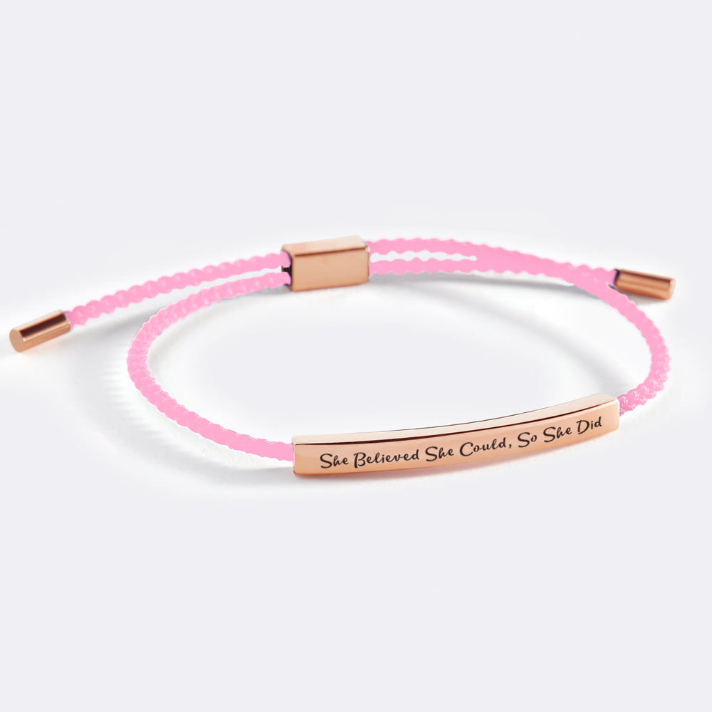 An inspirational bracelet with the message 'She Believed She Could, So She Did' printed on it, displayed on a white background with the text 'she believed she could, so she did' above it.
