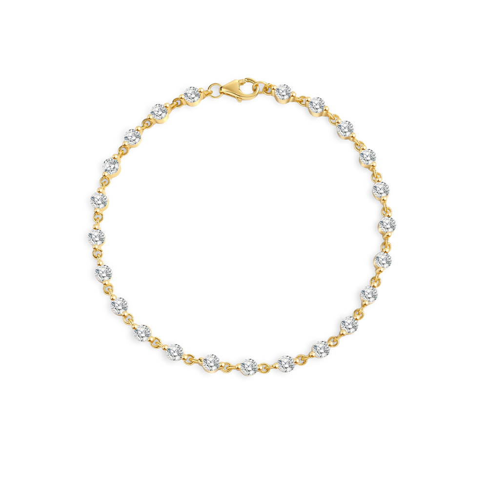 Gold bracelet with clear stones on a light gray background