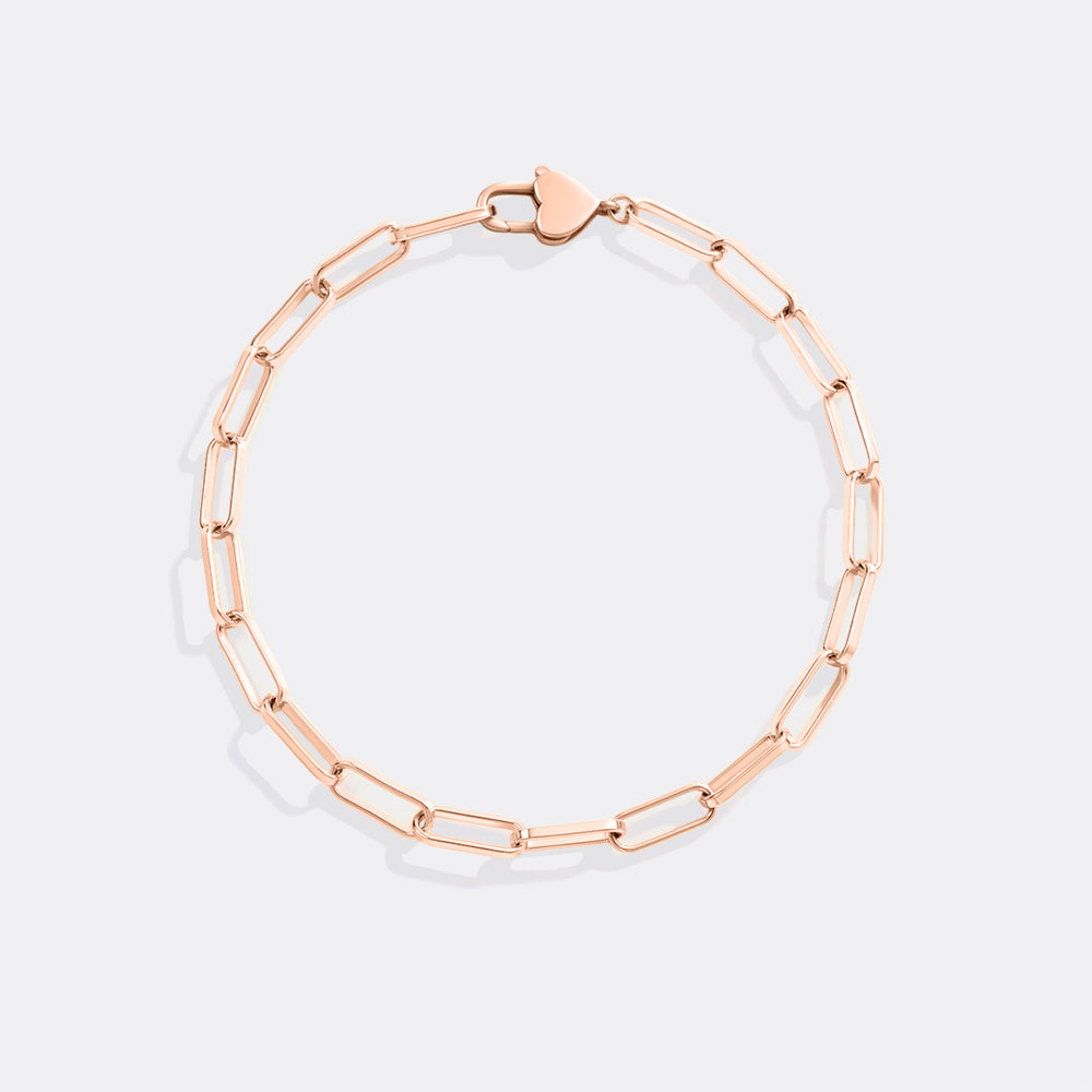 Rose gold chain bracelet on a light gray background