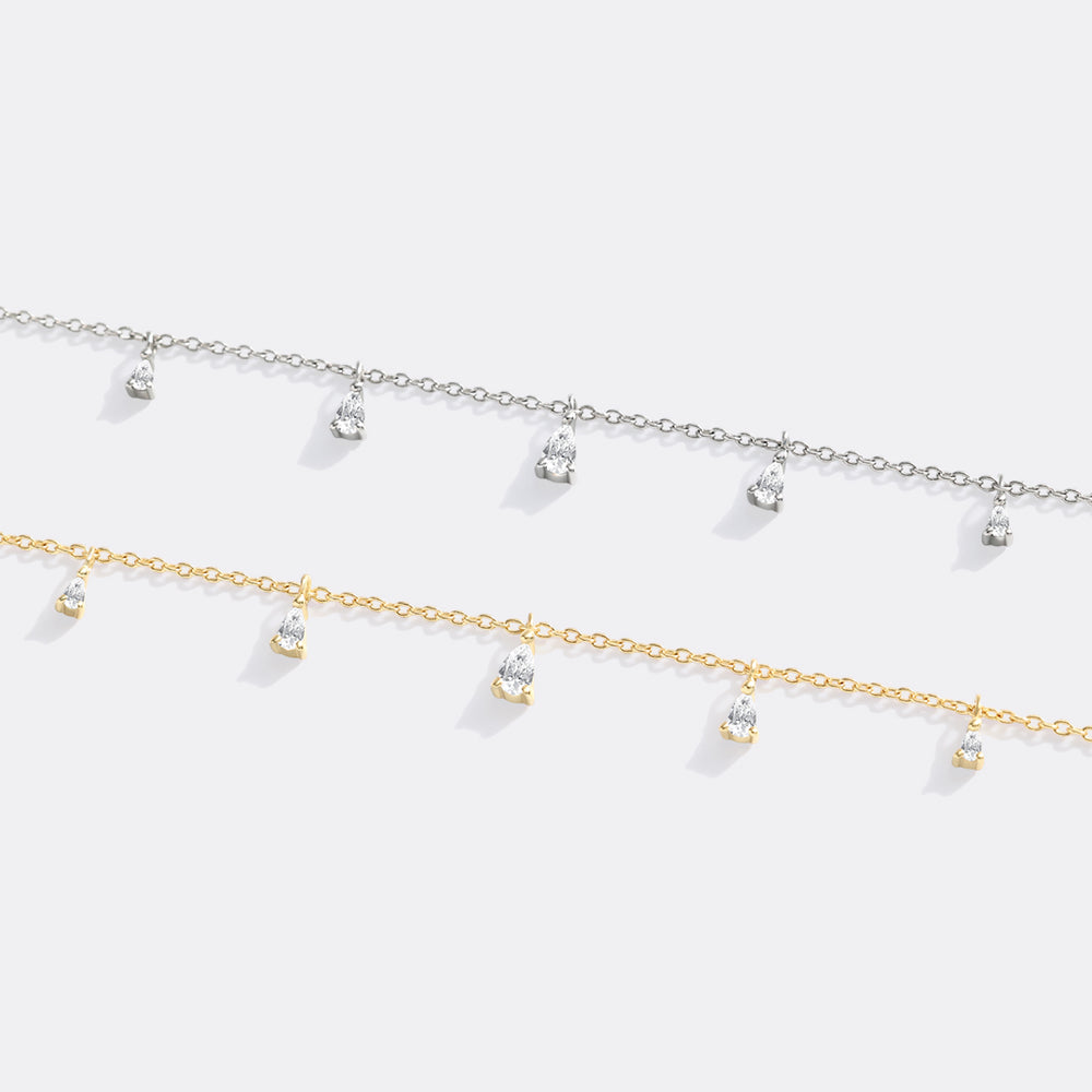 Two gold necklaces with small pendants on a white background