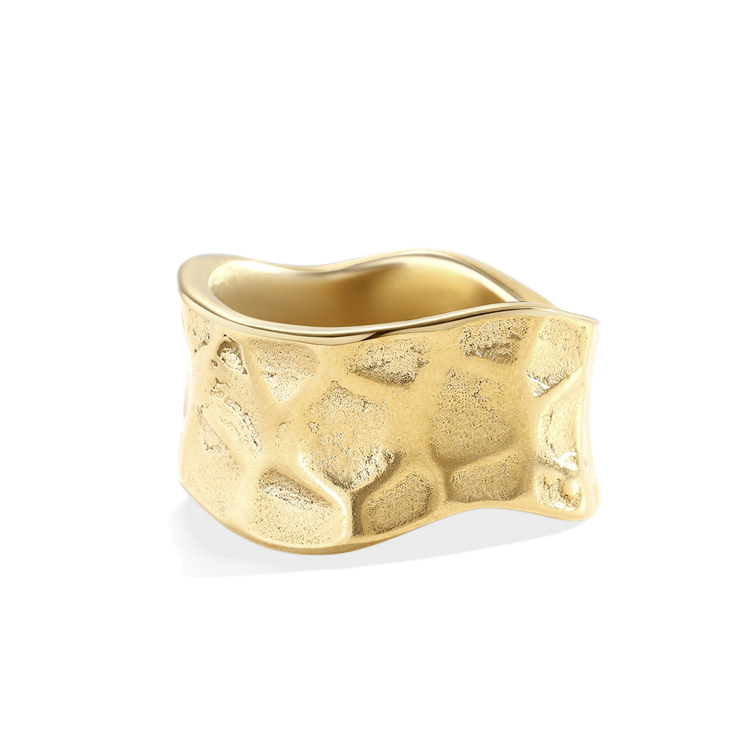 Gold ring with textured surface on a light gray background