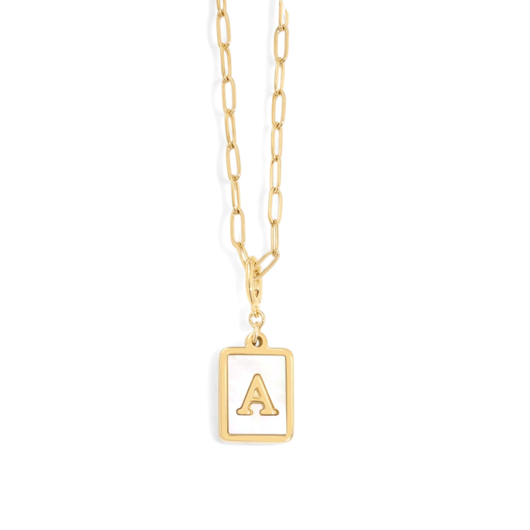 A gold-colored necklace with a paperclip chain and a mother of pearl pendant initial necklace 'C'.
