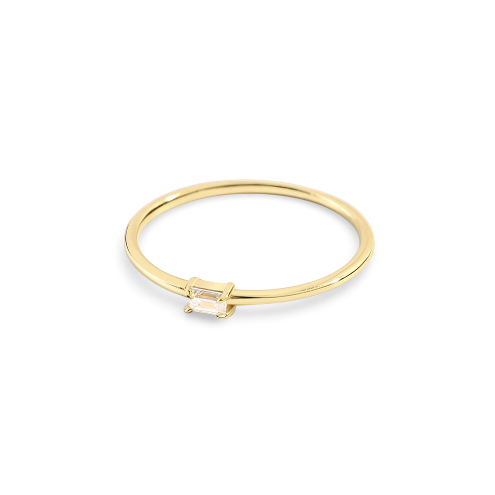 Gold ring with a small diamond on a light gray background