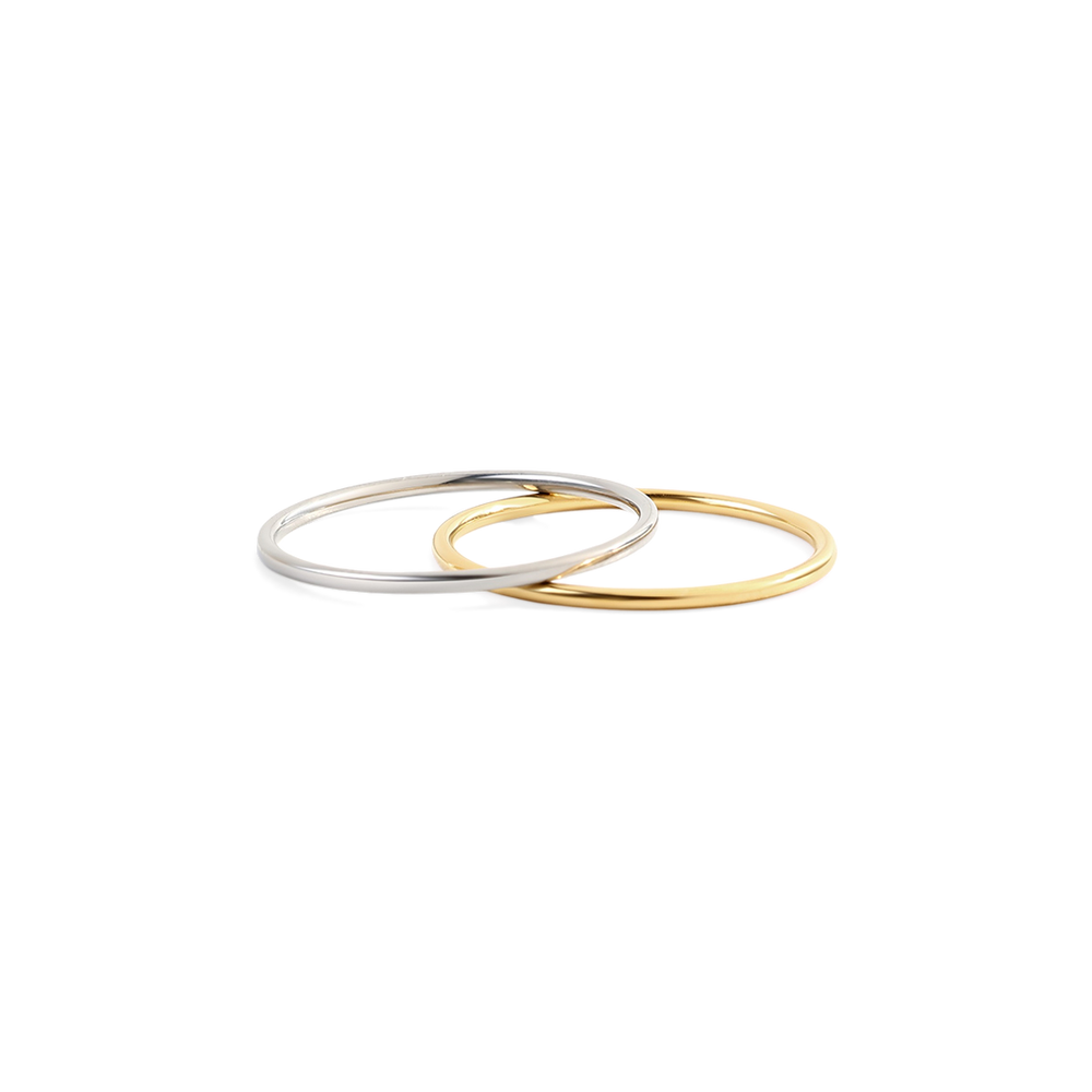 Two gold and silver bangles on a white background